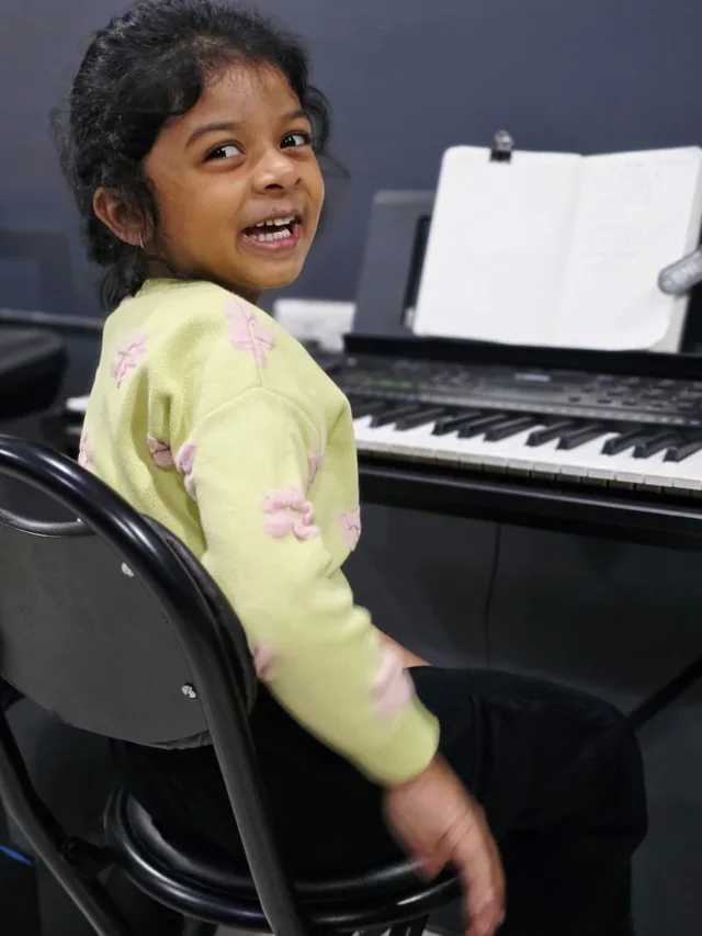A young student learning keyboard at Grace Music Academy
